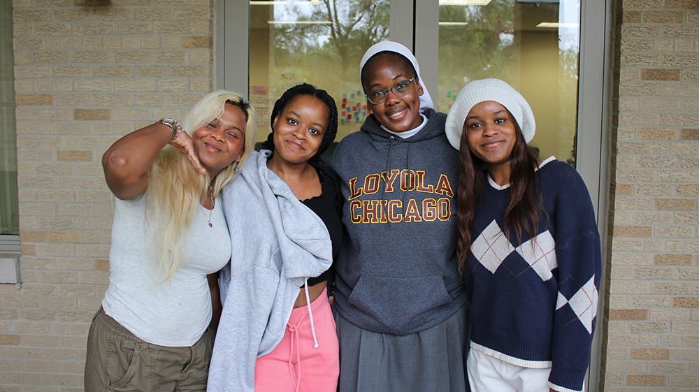 Four students smiling